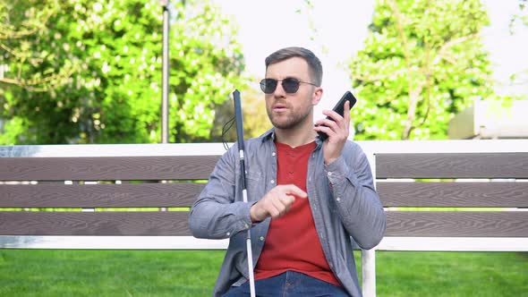 Blind Man with Disability Using Digital Assistant and Ease of Access Functions on Smartphone