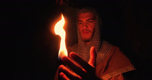 Viking Holds a Flame Torch in the Night