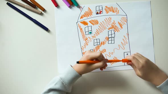 Child Drawing House Putting Heart Sign and Family Word on Cubes