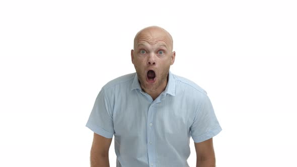 Middleaged Bald Bearded Man Wearing Blue Shirt Drop Jaw and Gasping Amazed Standing Fascinated and
