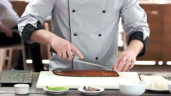 Sushi Chef Cutting Smoked Eel