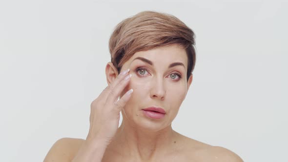 Close-up of middle aged mature woman over white background.