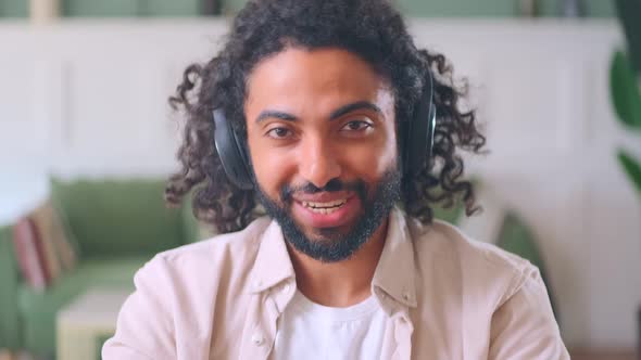 Young Arabian Man Wearing Headphones Talking Via Video Link Camera View