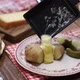 Putting melted raclette cheese on freshly boiled potatoes, swiss cuisine - VideoHive Item for Sale