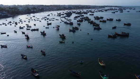 Aerial view of mui ne fishing harbor Vietnam Asia, catamaran fishing net traditional boat, drone rev