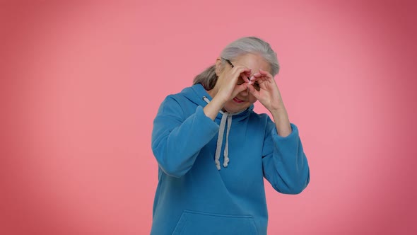 Nosy Curious Senior Granny Woman Closing Eyes with Hand Spying Through Fingers Hiding Peeping