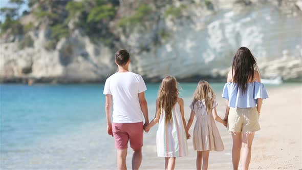 Happy Beautiful Family with Kids on the Beach