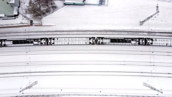 A Freight Train Travels Through a Snowcovered City