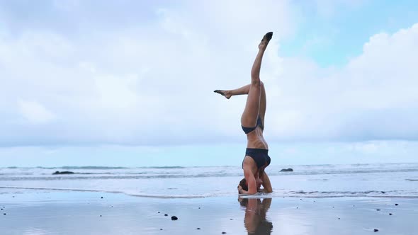 Flexible Yoga Woman Stretching Forward Bend Touching Forehead To Knees Outdoors Sunset Sea Beach