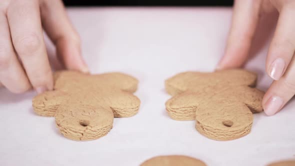 Decorating traditional gingerbread cookies with royal icing for Christmas.