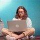 A Young Woman Wearing Glasses is Typing on a Laptop - VideoHive Item for Sale