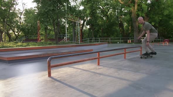 Skateboarder Doing a Tricks in a Concrete Skate Park