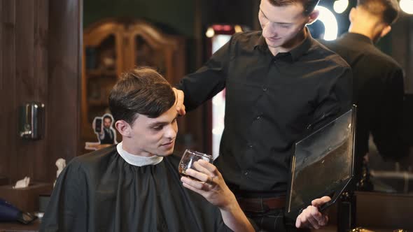 Client Drinking Whiskey Talking with Barber