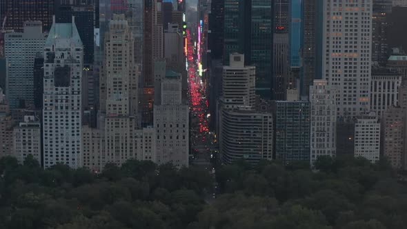 AERIAL: View of 7Th Avenue Traffic and Times Square Over New York City Central Park at Sunset with