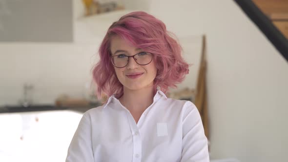 Smiling Young Hipster Teen Girl Pink Hair Looking at Camera in Sunny Kitchen