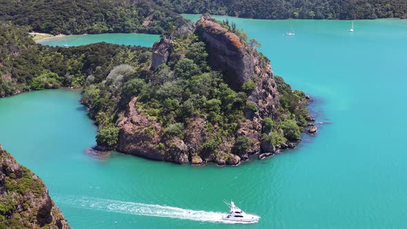 Beautiful wide shot from top of Kairara Rock of Yacht sailing on beautiful blue sea. Dukes Nose Trac