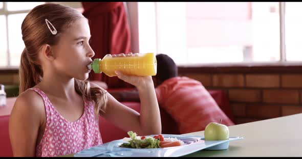 Portrait of schoolgirl having breakfast