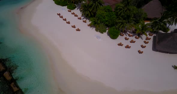 Luxury aerial travel shot of a white paradise beach and turquoise sea background in high resolution 