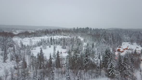 Aerial View of Village in Snowy Forest