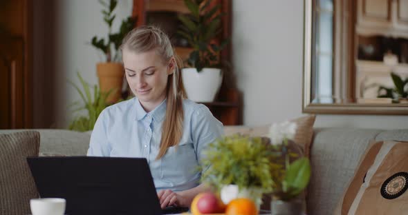 Home Office Concept - Woman Typing on Laptop Keyboard.