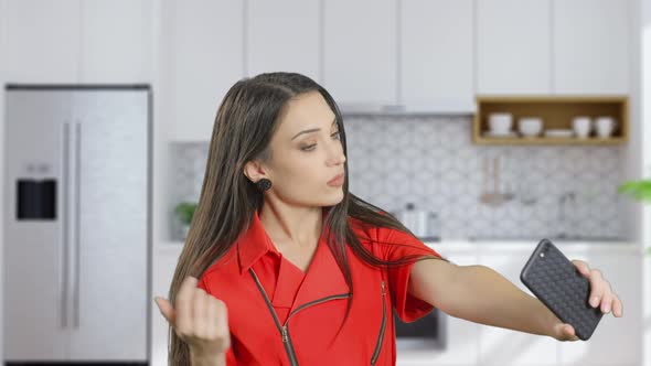 A Beauty Woman Is Taking Selfie Photo By Phone on the Kitchen at Home