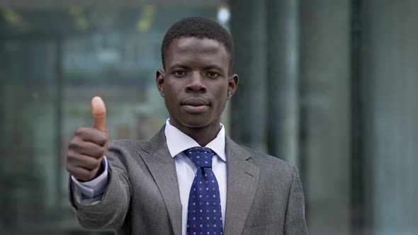 Young African American businessman making thumb up. Positivity,optimism -outdoor