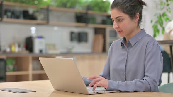 Indian Woman with Laptop Showing Thumbs Down Sign