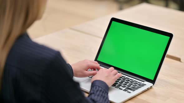 Rear View of Businesswoman Using Laptop with Chroma Screen