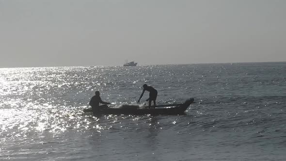 People fishing in ocean in morning, traditional boat fishing in sea. Sea fishing boat in morning.