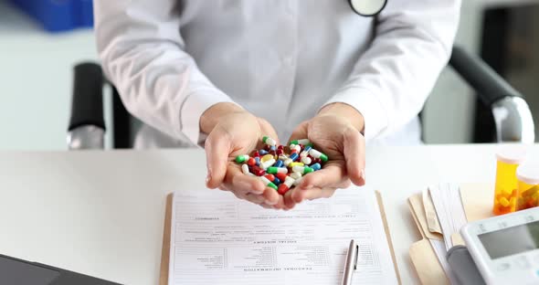 Woman Doctor Holding Many Multicolored Capsules in Her Hands in Clinic  Movie Slow Motion