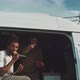 Two men sitting in the back of a van eating and drinking - VideoHive Item for Sale