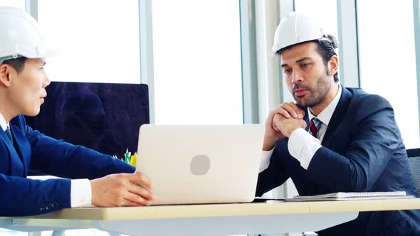 Engineer and Architect Meeting at Office Table