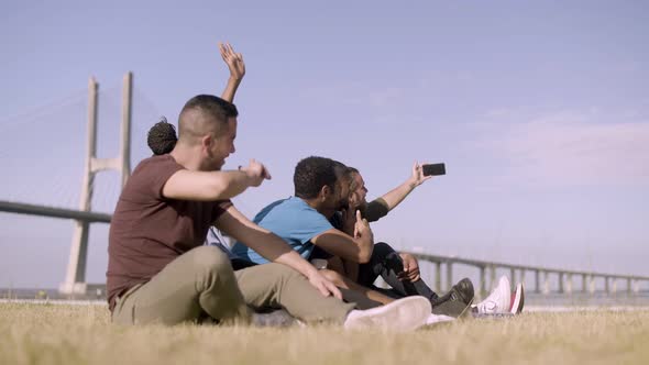 Smiling Friends Gesturing While Taking Self Portrait with Smartphone