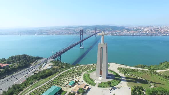 Aerial view of Sanctuary of Christ the King overlooking Lisbon and 25 de Abril Bridge connecting Lis