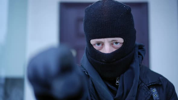 Closeup Portrait of Masked Man Pointing Looking at Camera Standing at Background of House