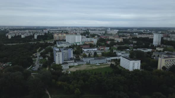 City block. Modern multi-storey buildings. Flying at dusk at sunset. Aerial photography.