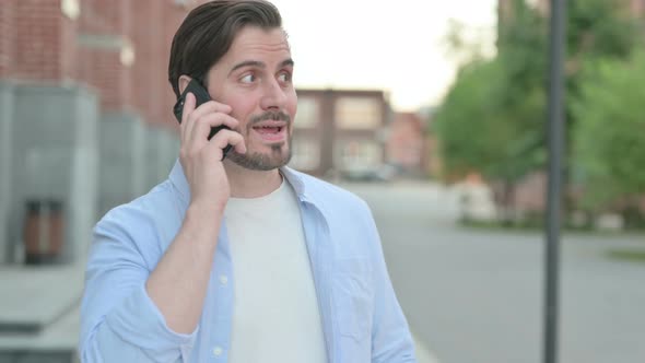 Man Talking Angrily on Smartphone