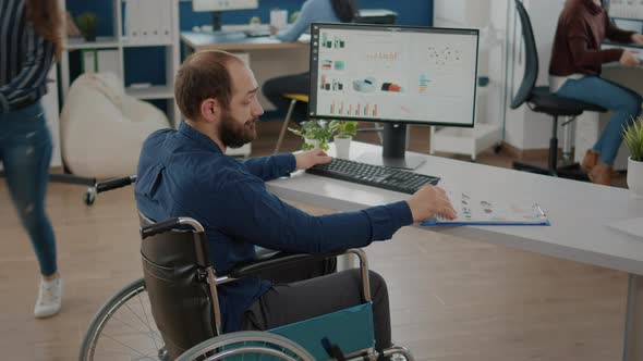 Paralized Manager Working in Start Up Business Office Sitting in Wheelchair