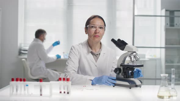 Female Biomedical Scientist Posing for Camera in Lab