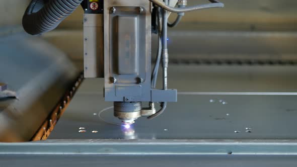 Laser cut machine while cutting the sheet metal with sparks and high precision