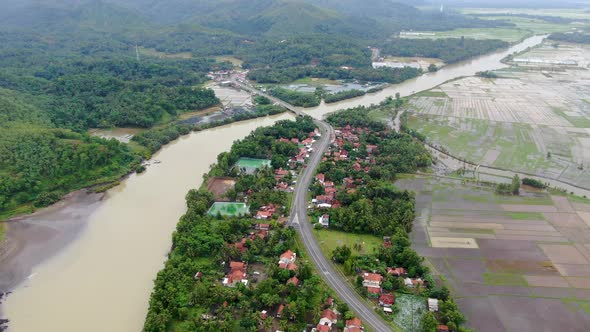 Telomoyo river and surrounding rural landscape, Kebumen district in Indonesia. Aerial forward