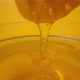 Honey Dripping Pouring From a Honey Dipper Into a Glass Bowl - VideoHive Item for Sale