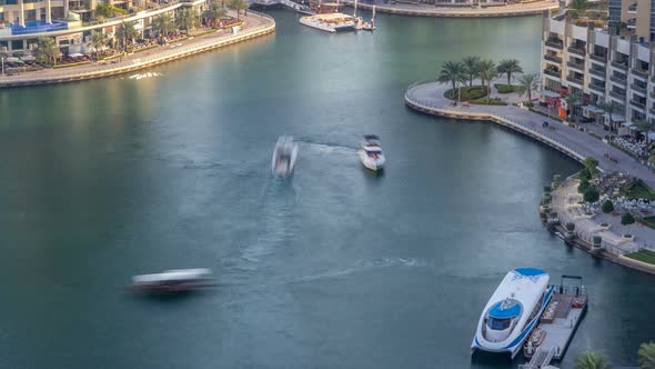 Luxury Dubai Marina Canal with Passing Boats and Promenade Timelapse Dubai United Arab Emirates