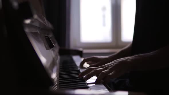 Closeup of Male's Hands Practicing to Play the Piano at Home