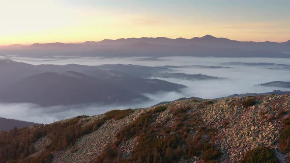 Foggy mountains in the morning at sunrise from aerial view