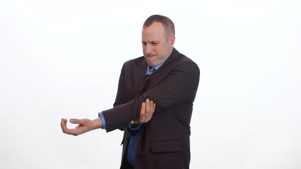 Man rubs sore elbow on white background.