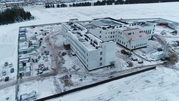Public Building Construction Site in Snowy Field at Suburb
