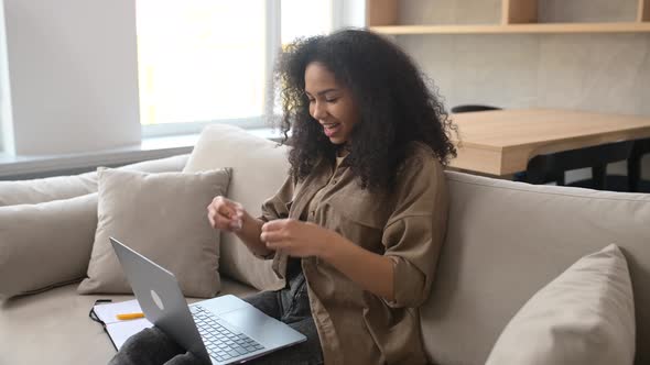 Charming Smiling AfricanAmerican Woman Entrepreneur Using Laptop for Video Connection