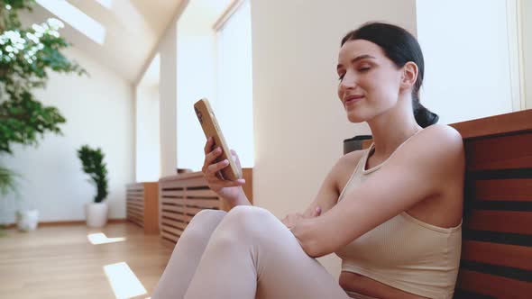 Smiling young woman typing on mobile