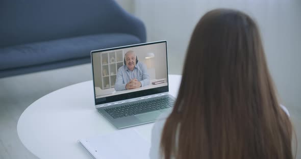 High Angle View of Video Conference with Teacher on Laptop at Home. Girl in Video Call with Personal